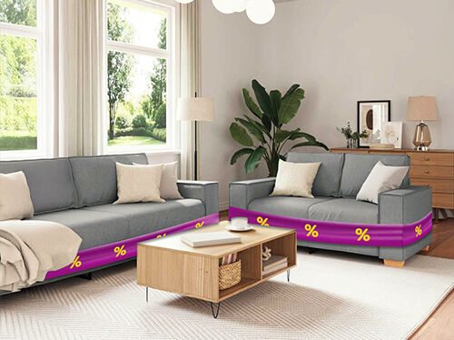 Two grey sofas wrapped in purple promotional bands showing yellow discount icons and wooden coffee table, in a styled living room. Click to see the products in the offer.