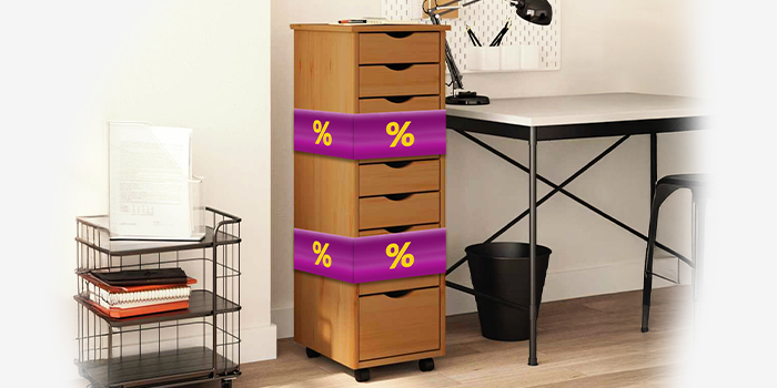 Light-colored wooden storage cabinet with purple promotional bands showing yellow discount icons, in a styled office room. Click to shop the collection.