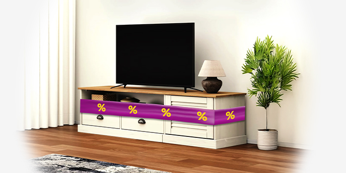Two-toned TV stand with TV on it, wrapped in a purple promotional band showing yellow discount icons, in a styled living room. Click to shop the collection.